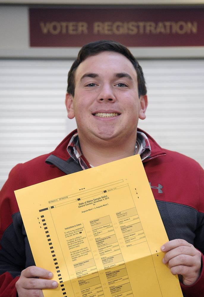 Ryan Dumont holds a sample ballot Monday at Augusta City Center. Dumont will cast his first ballot when he turns 18 on Election Day.