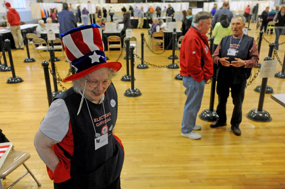 Germaine Gooldrup, an election volunteer at the American Legion on College Avenue in Waterville, directs voters to the proper lines to pick up their ballots during mid-term elections on Tuesday.