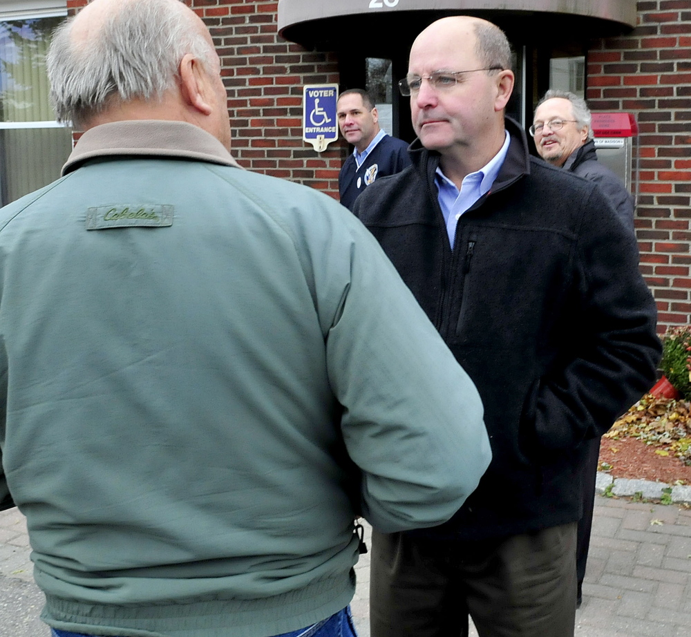 Somerset Sheriff candidate Dale Lancaster, right, speaks with Philip Morey outside the Madison Town Hall on Tuesday,  during an Election Day stop. In back are local candidates Brad Farrin, left, and Rob Washburn.
