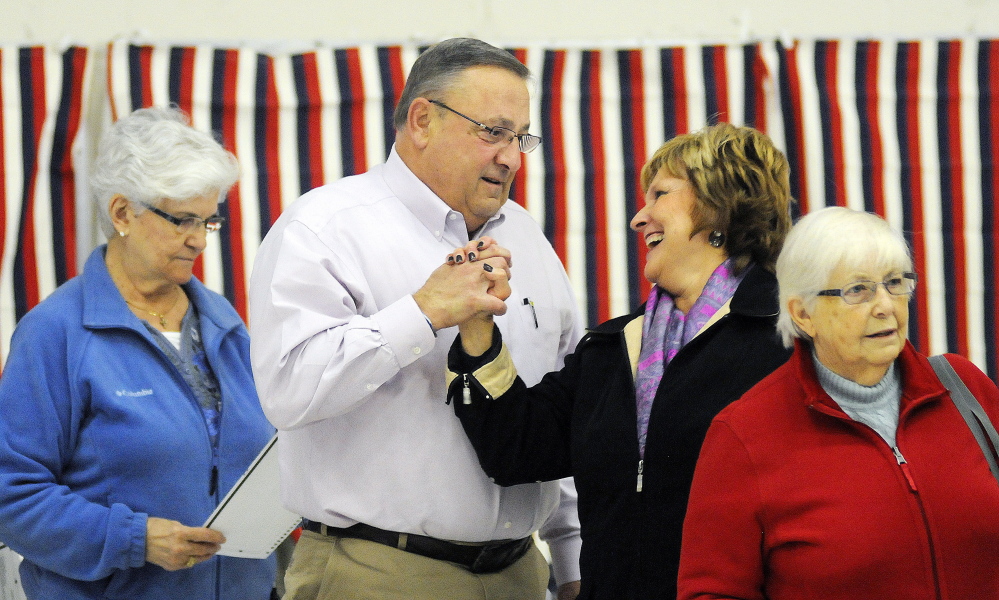 Gov. Paul LePage greets first lady Ann LePage after voting Tuesday in Augusta. A topic of speculation for his second term is whether he will govern with a less confrontational style than in his first four years.