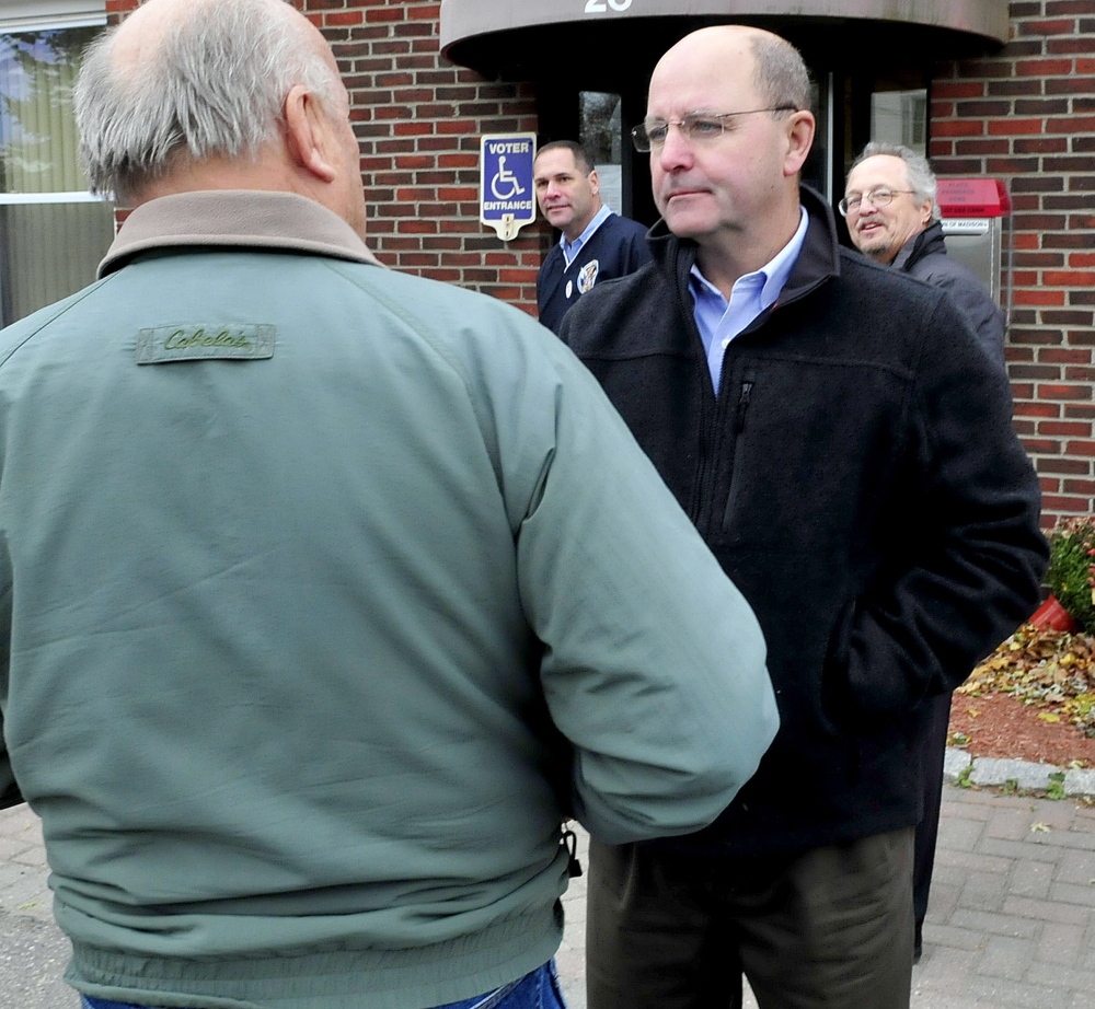 Somerset County Deputy Sheriff Dale Lancaster, right, speaks with Philip Morey outside the Madison Town Hall on Tuesday during an Election Day stop. Lancaster won the race for Somerset County sheriff against Kris McKenna.