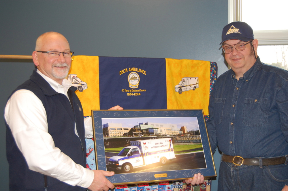 Delta Executive Director Tim Beals recognizes paramedic Paul Mathieu for 40 years of service Oct. 31 at the ambulance company’s Waterville office.