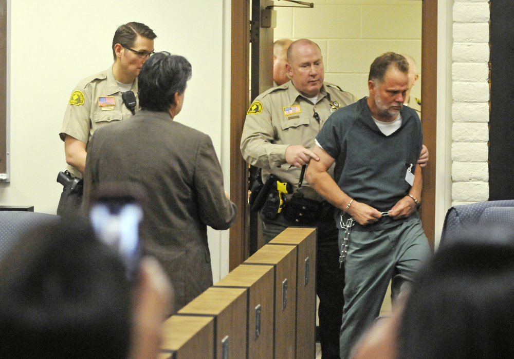 Charles “Chase” Merritt, 57, is led into court for an arraignment hearing at the the Victorville Courthouse Friday, in Victorville, Calif.