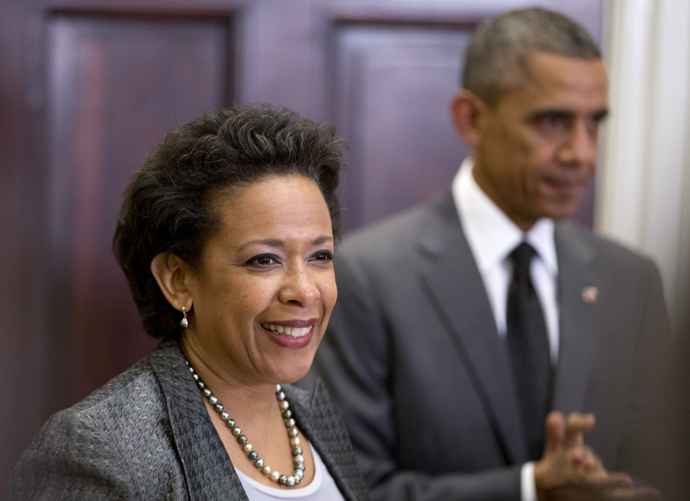 President Barack Obama listens as US Attorney Loretta Lynch speaks in the Roosevelt Room of the White House in Washington on Saturday, where the president announced he would nominate Lynch to replace Attorney General Eric Holder.