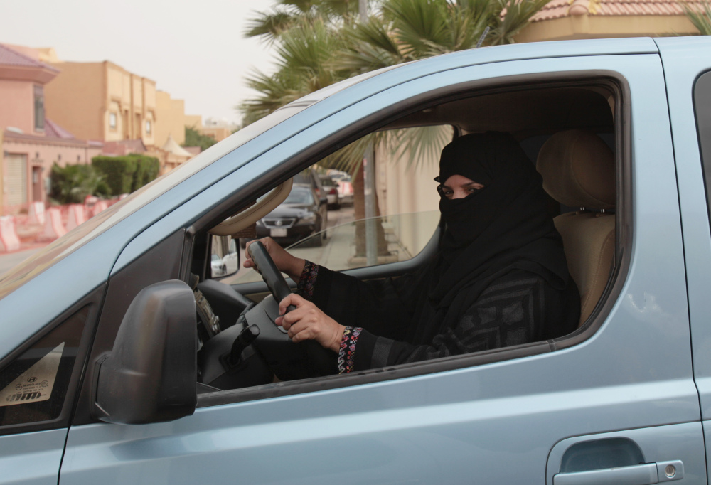 In this photo  from March 2014, Aziza Yousef drives a car in Riyadh, Saudi Arabia, as part of a campaign to defy Saudi Arabia’s ban on women driving. A Saudi official said Friday that the kingdom’s advisory council has recommended to the government for the first time the partial lifting of the ban on women driving, but with conditions: Only women over 30, only during the day, and no makeup allowed while driving.