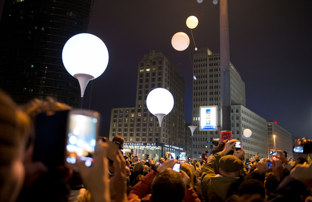 Balloons fly away at Potsdamer Platz in the center of Berlin on Sunday to commemorate the fall of the Berlin Wall in Germany 25 years ago on Nov. 9, 1989.
