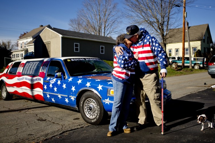Rita Dearborn and her husband Larry share a kiss on Saturday as they stand at the front of his 1997 Lincoln Town Car Limousine that they drive around the state to honor veterans of America’s wars. The Dearborns plan to take part in this year’s parade in Richmond.