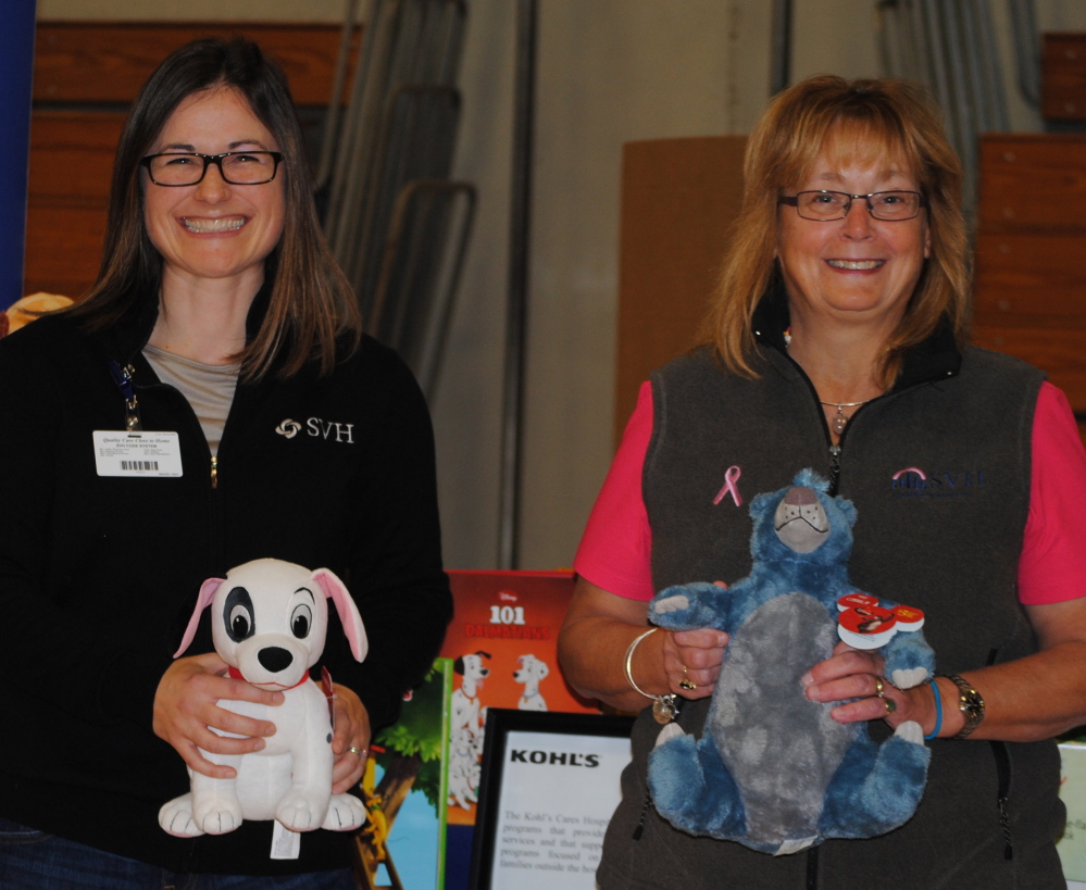 Karen Hawkes, SVH Director of Occupational and Community Health, left, and Terri Vieira, SVH President/CEO and EMHS Senior Vice President stand with Kohl’s Cares merchandise during the SVH Community Health Fair held in Pittsfield. Kohls donated the items for the fair.
