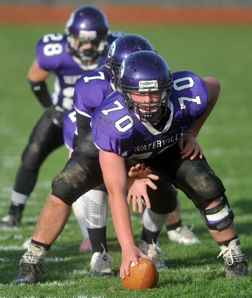 Waterville Senior High Schoo’s center, Ben Cox, prepared to snap the ball to quarterback AJ Godin (7) during a recent game. Cox’ brother Tom was a Waterville captain in 2012.