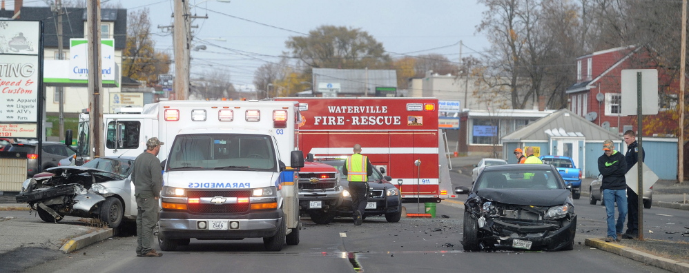 Waterville fire department and Delta Ambulance work to extricate Heather Wadsworth from her car after she collided with another vehicle on the southbound lane on College Avenue near the intersection of Oak Street in Waterville on Friday.