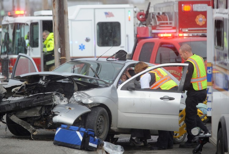 Waterville fire department and Delta Ambulance work to extricate Heather Wadsworth from her car after she collided with another vehicle as she pulled out of Oak Street onto College Avenue in Waterville on Friday.