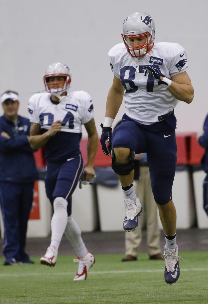 New England Patriots tight end Rob Gronkowski (87) and wide receiver Brian Tyms (84) stretch before a recent practice in Foxborough, Mass. The Patriots will play the Indianapolis Colts Sunday in Indianapolis.