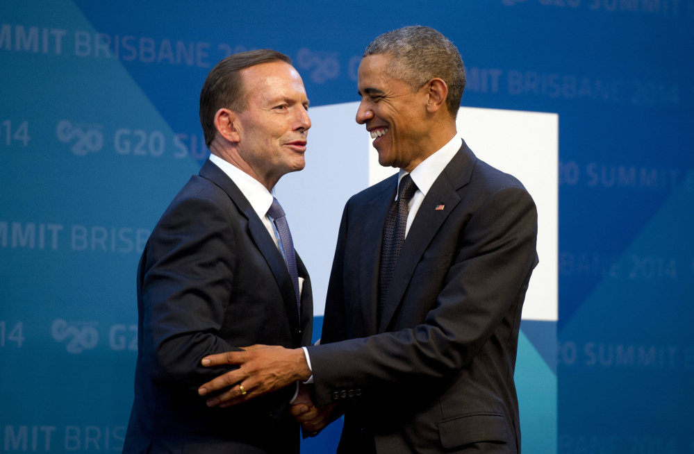 U.S. President Barack Obama, right, is welcomed by Australia’s Prime Minister Tony Abbott upon arrival for the G20 Summit in Brisbane, Australia, on Saturday.