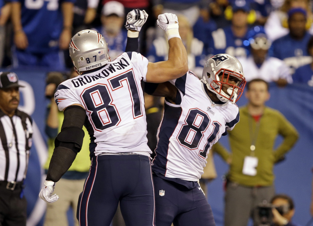 New England Patriots tight end Tim Wright, right, celebrates his touchdown catch with teammate Rob Gronkowski during the second half Sunday night against the Indianapolis Colts in Indianapolis. The Patriots won 42-20 and have an 8-2 record.