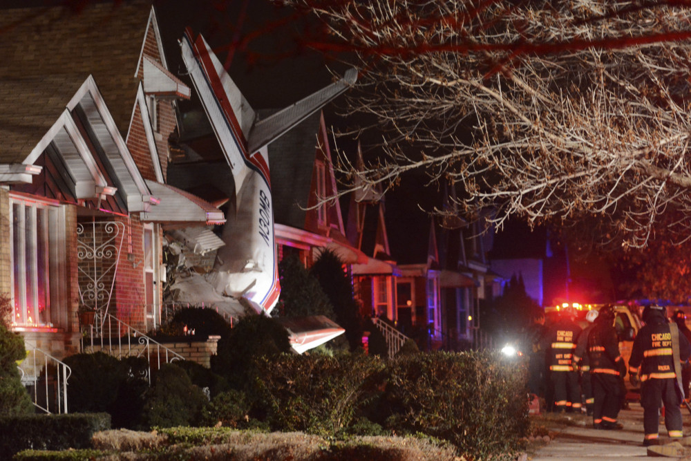A small twin-engine cargo plane is seen after it crashed into a home on Chicago’s southwest side early Tuesday shortly after taking off from Midway International Airport.