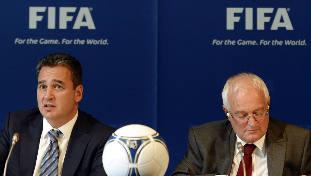 In this Friday, July 27, 2012 file photo, Chairmen of the two chambers of the new FIFA Ethics Committee Michael Garcia, left, from the US and Joachim Eckert, right, from Germany attend a press conference, at the Home of FIFA in Zurich, Switzerland.
