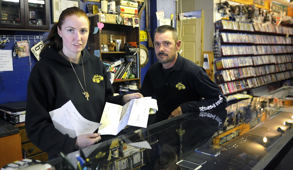 Amanda Bosse and Edwin Harris behind the counter of their Augusta pawn shop, A&E Trading, on Tuesday. The proprietors recently won a court judgment to have a silver bar, seized by Augusta Police on suspicion it was stolen, returned to them.