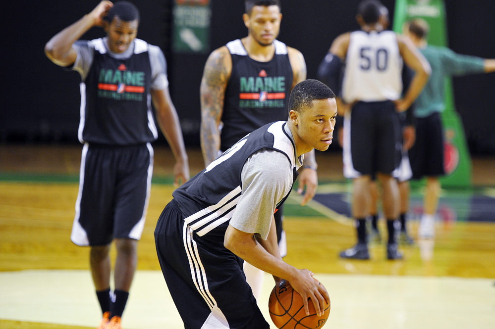 Tim Frazier works the ball with his teammates during practice at the Red Claws Media Day on Tuesday in Portland.