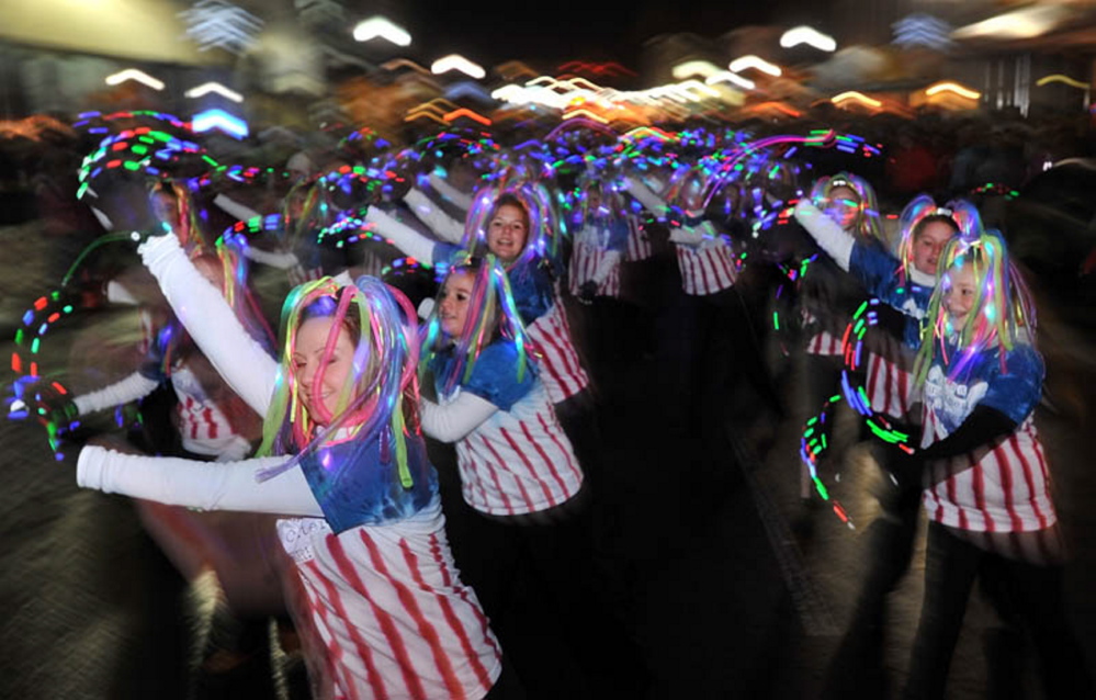 Members of the Young Americans Dance center dance their way down Main Street in downtown Waterville during the annual Parade of Lights in 2011. Lights are mandatory for all marchers during the annual festival.
