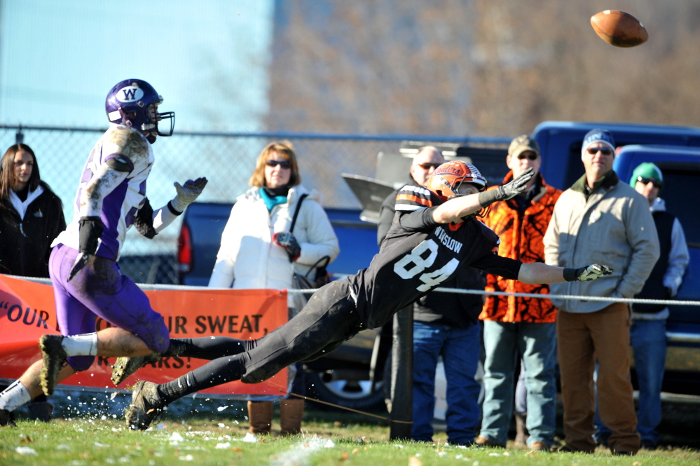 Winslow receiver Justin Martin, right, dives to try and catch a pass during the Eastern Class C title game against Waterville last weekend. Winslow will play Leavitt for the Class C state title Friday night at the University of Maine.
