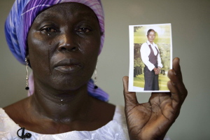 In this May 19 file photo, Martha Mark, the mother of kidnapped school girl Monica Mark cries as she displays her daughter's photo, in the family house, in Chibok, Nigeria. In a video released Oct. 31, Abubakar Shekau, the leader of Nigeria's Islamic extremist group Boko Haram, dashed hopes for a prisoner exchange to get the girls released. "The issue of the girls is long forgotten because I have long ago married them off," he said, laughing. (AP file photo)