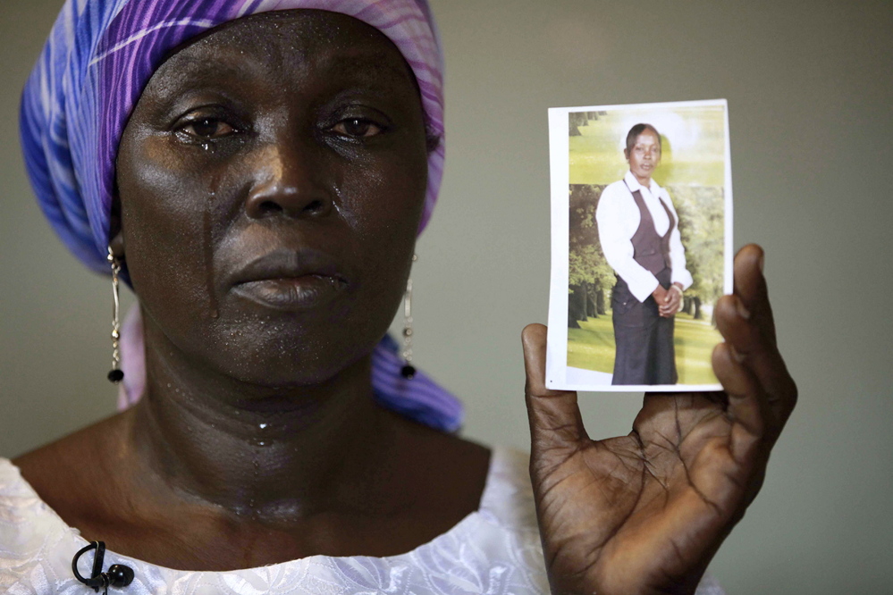 In this Monday, May 19, 2014 file photo, Martha Mark, the mother of kidnapped school girl Monica Mark cries as she displays her photo, in the family house, in Chibok, Nigeria. In a video released Oct. 31, the leader of Nigeria's Islamic extremist group Boko Haram, Abubakar Shekau dashed hopes for a prisoner exchange to get the girls released. "The issue of the girls is long forgotten because I have long ago married them off," he said, laughing. (AP file photo)