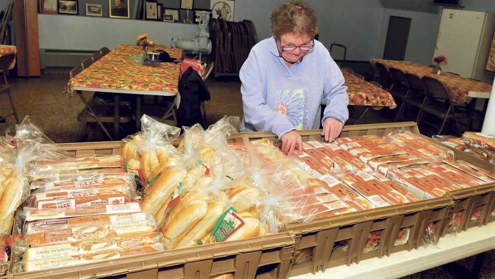 Volunteer Roberta Lessard looks over the offerings of bread at the St. Anthony’s Soup Kitchen in Skowhegan on Thursday