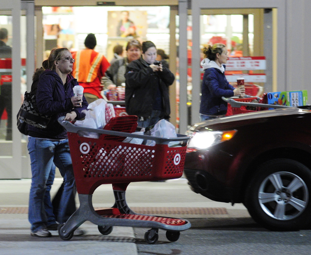 Shoppers roll carts out of the Target store at 5:07 a.m. on Black Friday last year in Augusta.