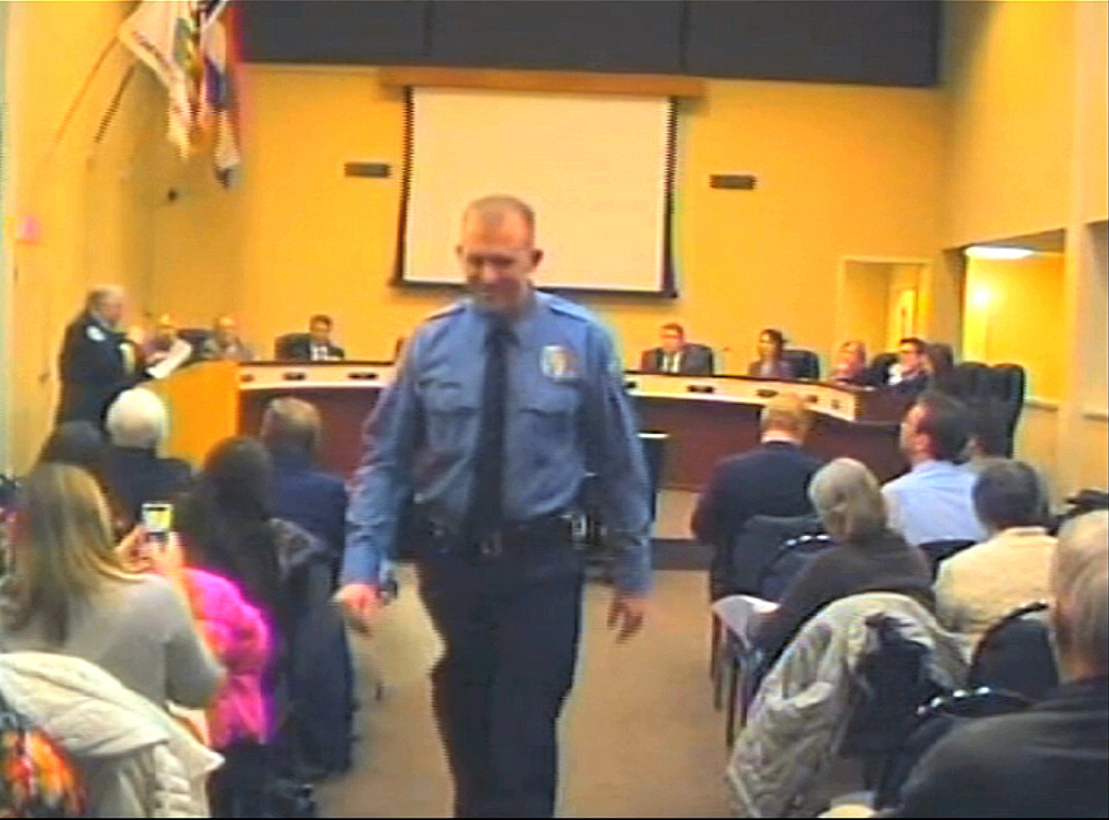 In this  Feb. 11, 2014 file image from video provided by the City of Ferguson, Mo., officer Darren Wilson attends a city council meeting in Ferguson. Wilson is not expecting to face criminal charges from a Missouri grand jury that has been investigating the nationally watched case for the past several months, a police union official said Thursday.