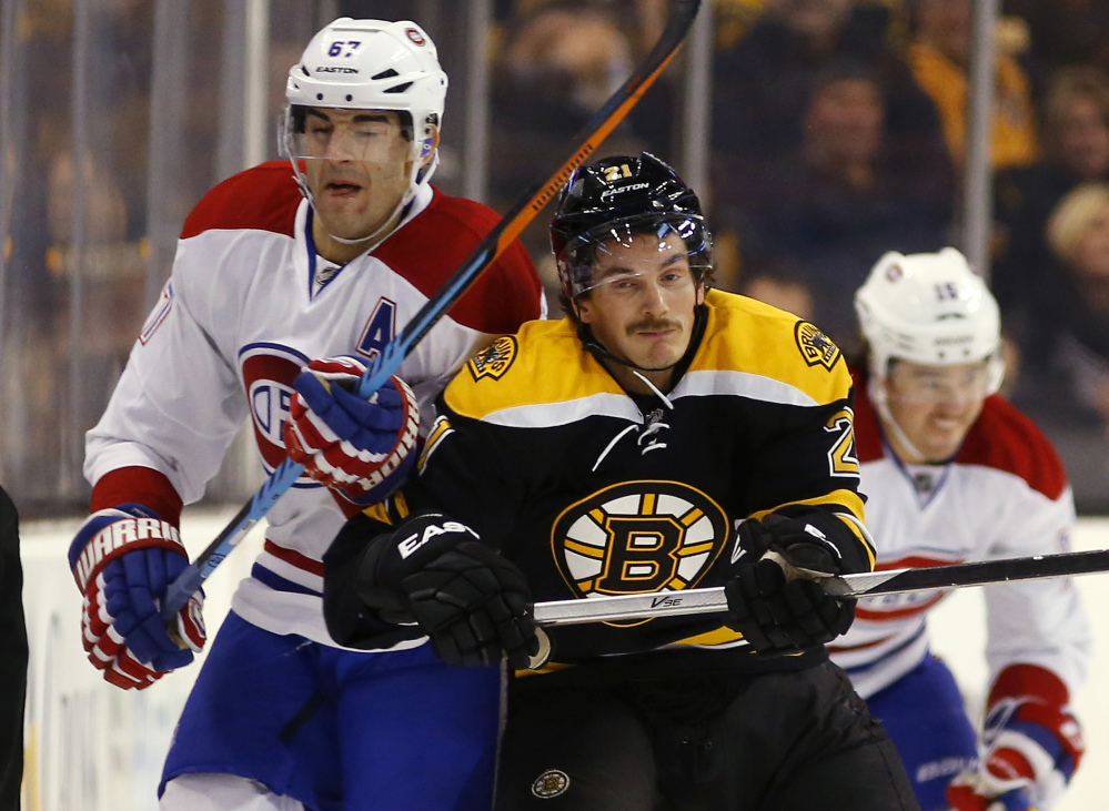 Boston Bruins’ Loui Eriksson, front right, checks Montreal Canadiens’ Max Pacioretty during the first period Saturday in Boston. Montreal won 2-0.