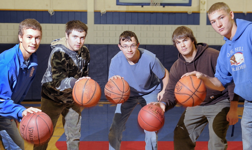 Oak Hill High School students, from left, Dalton Therrien, Logan Montminy, Sam Guilford, Garrett Gile and Levi Buteau, dribble in the school’s gym earlier this month. The group participated in a unified tournament at the University of Southern Maine last spring.
