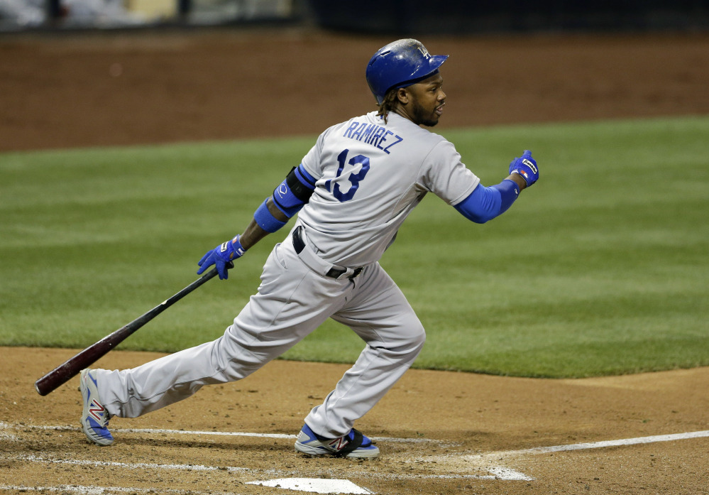 In this Aug. 29, 2014, file photo, Los Angeles Dodgers’ Hanley Ramirez follows through after hitting an RBI-double against the San Diego Padres during the third inning in a baseball game in San Diego.