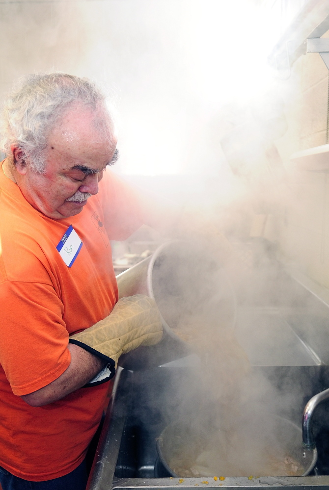 Steam swirls around Ron Emery as he pours a pot of broth through a colander while making gravy for a community Thanksgiving dinner Thursday at Gardiner Area High School.