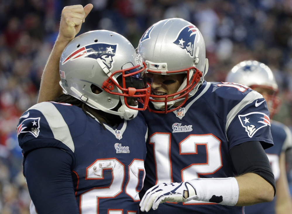 New England Patriots quarterback Tom Brady, right, congratulates running back LeGarrette Blount on his touchdown in the fourth quarter last Sunday against the Detroit Lions in Foxborough, Mass. The Patriots play the Green Bay Packers on Sunday at Lambeau Field in Green Bay, Wisc.