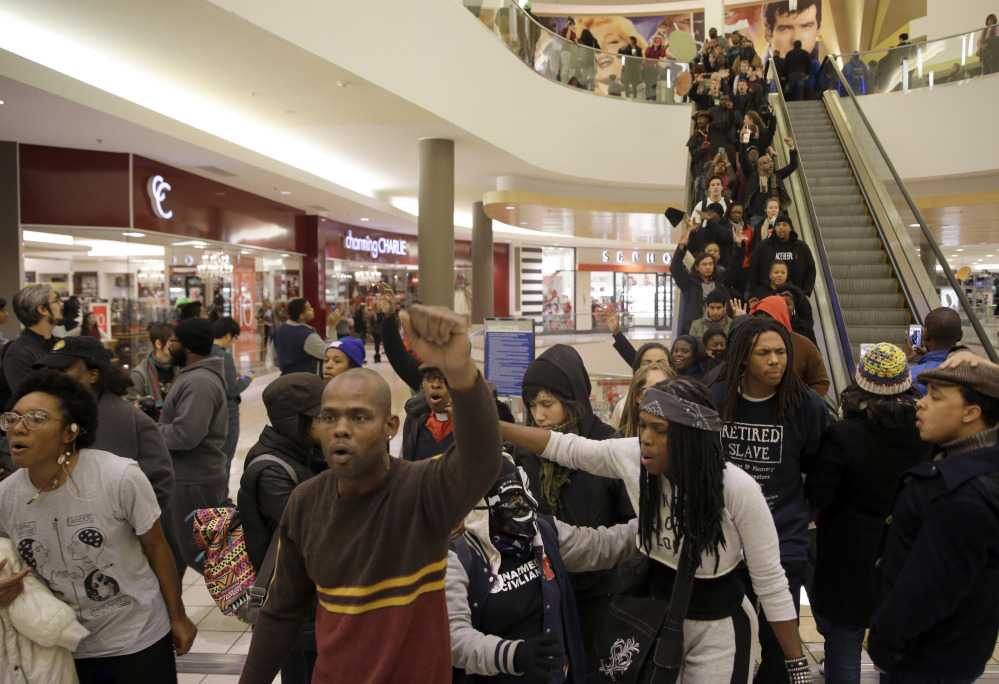 The Associated Press Protesters march inside Chesterfield Mall Friday in Chesterfield, Mo. The crowd disrupted holiday shopping at several locations on Friday amid a protest triggered by a grand jury’s decision not to indict the police officer who fatally shot Michael Brown in nearby Ferguson.