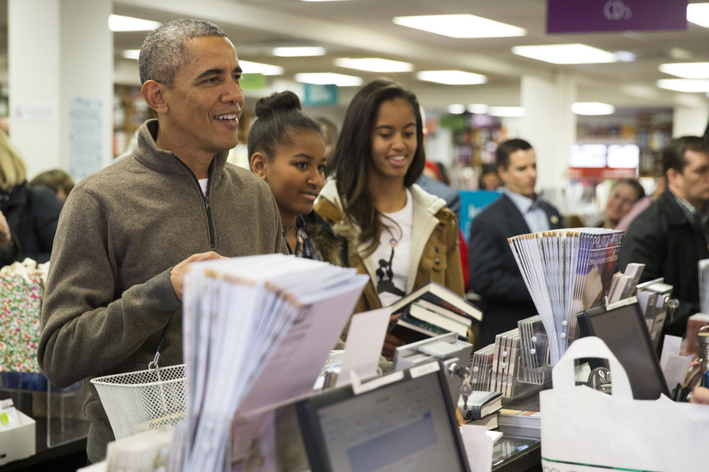 The Associated Press President Barack Obama, left, shops with his daughters, Sasha, center, and Malia, at Politics and Prose bookstore for “Small Business Saturday,” on Saturday in Washington.