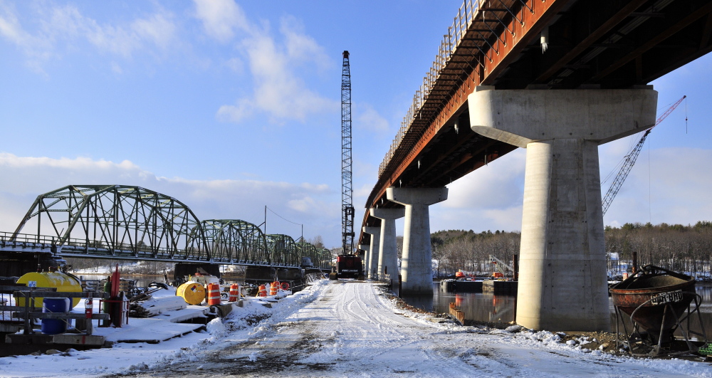 The old green metal bridge spanning the Kennebec River between Richmond and Dresden will be replaced by the new taller bridge with concrete supports following a Friday ceremony.