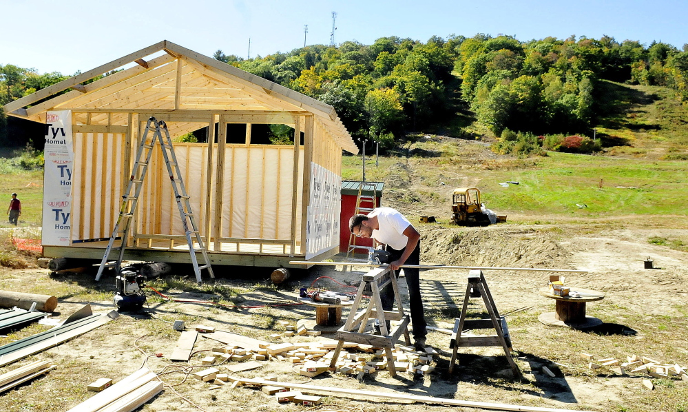 Dave Beers, owner of Eaton Mountain Ski Center in Skowhegan works on a new snow-tube storage building at the base of the resort on Sept. 24, 2014. Beers said that downhill skiing on the lower portion, background, will be available this winter. He added the facility usually opens around Christmas time. If weather allows, he will be making snow in December.