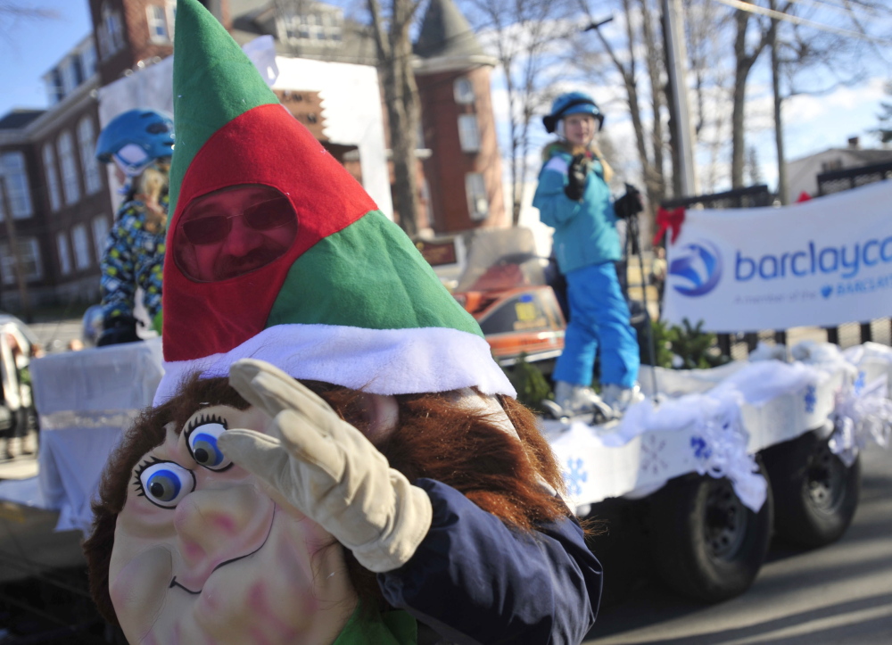Dan Farrington, dressed as an elf, waves to the crowd on Main Street during the annual Chester Greenwood Day parade in downtown Farmington in December 2013.