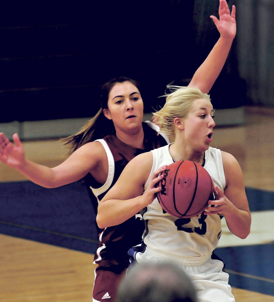 Colby College’s Carylanne Wolfington looks to pass under pressure from Bate’s Allie Coppola during a game on Sunday.