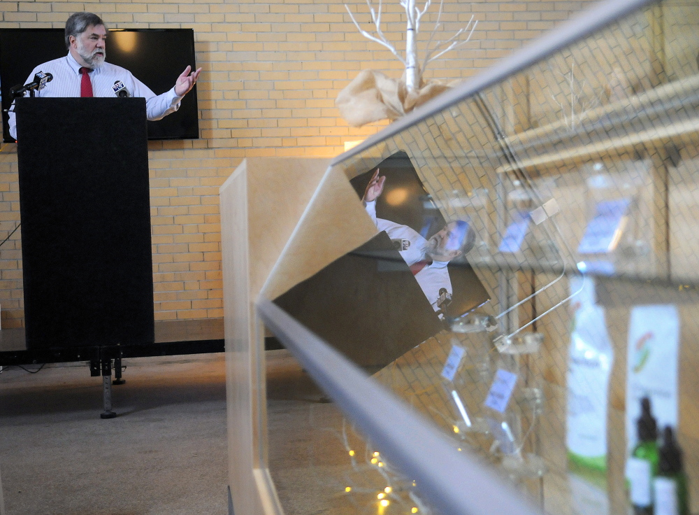 Gardiner Mayor Thomas Harnett addresses folks who attended the Monday opening of the Wellness Connection of Maine dispensary at the historic train station in Gardiner. Items for sale behind the glass case include tinctures of marijuana.