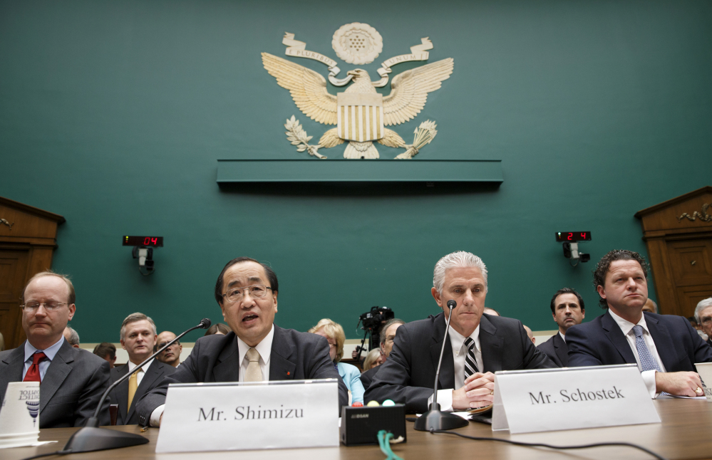 Hiroshi Shimizu, center left, senior vice president of global quality assurance at Takata, joined at right by Rick Schostek, executive vice president of Honda North America, and Craig Westbrook, far right, vice president for aftersales for BMW of North America, testifies on Capitol Hill in Washington, Wednesday, before the House Commerce, Manufacturing, and Trade subcommittee heating to examine ruptures and recalls of defective air bags made by Takata.