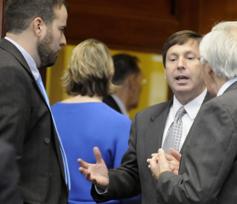 Republican Minority Leader Rep. Ken Fredette of Newport argues with Democratic Reps. John Martin of Eagle Lake, right, and Jeff McCabe of Skowhegan in the well of the House of Representatives in Augusta.