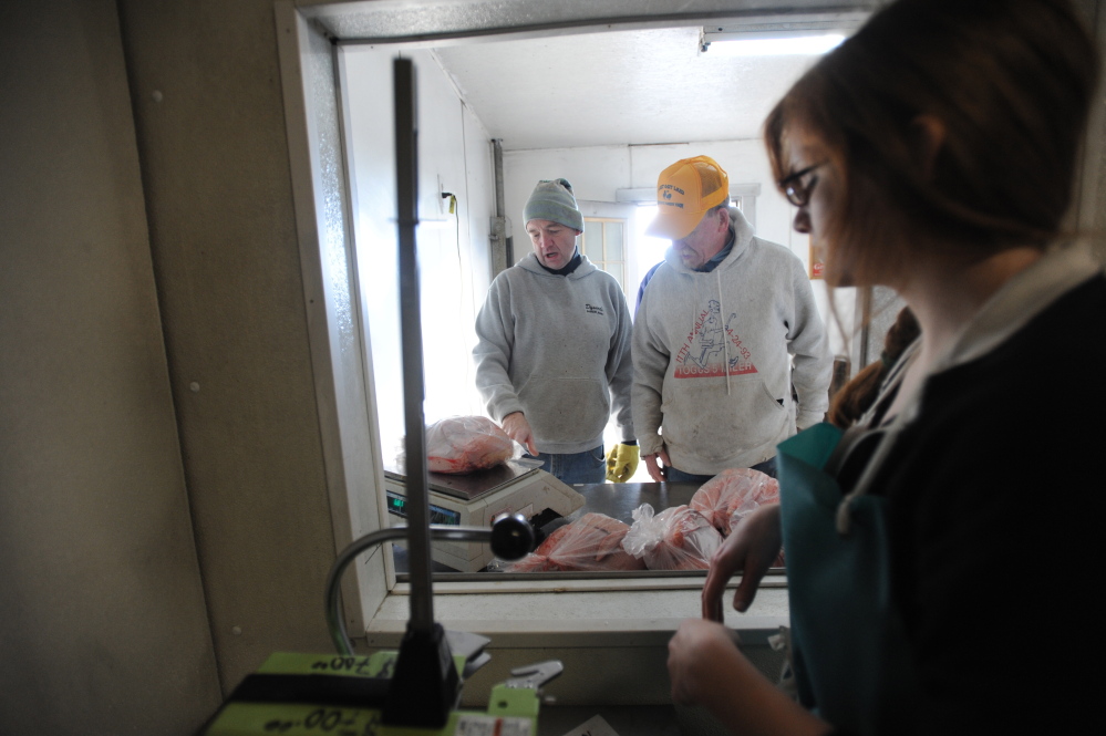 MERCER, MAINE - NOVEMBER 8, 2014. 
 Scott Greaney, left, talks with a customer on one of the walk-in slaughter days at Greaney's Turkey Farm Saturday, Nov. 8, 2014. Scott has been relegated to customer work and tasks away from the slaughter due to his cancer treatment and compromised immune system. (Staff photo by Michael G. Seamans)