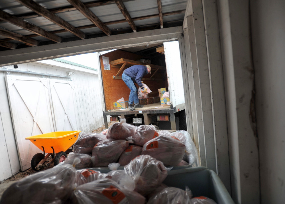MERCER, MAINE - NOVEMBER 22, 2014. 
 Bob Spear, owner of Spear's Farm Stand in Waldobor, loads one of the 75 turkeys they bought on to his refrigerated box truck at Greaney's Turkey Farm in Mercer on Saturday, Nov. 22, 2014. The Spears have been purchasing the turkeys for the past six years. (Staff photo by Michael G. Seamans)