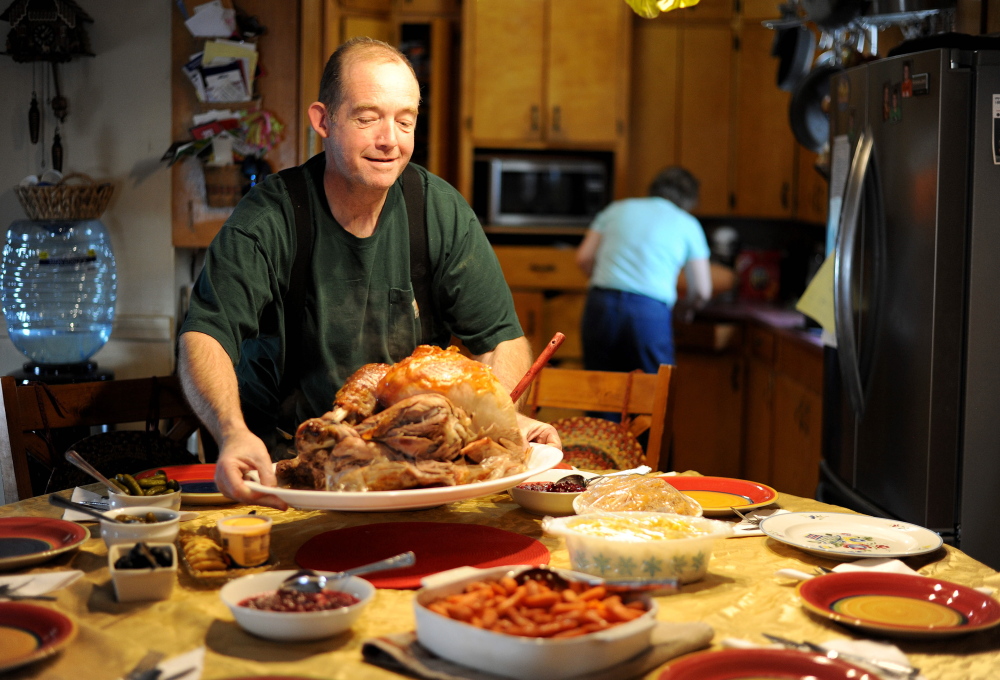 MERCER, MAINE - NOVEMBER 27, 2014. 
 Scott Greaney places the family turkey on the table ahead of Thanksgiving dinner at the family's home in Mercer on Thursday, Nov. 27, 2014. (Staff photo by Michael G. Seamans)