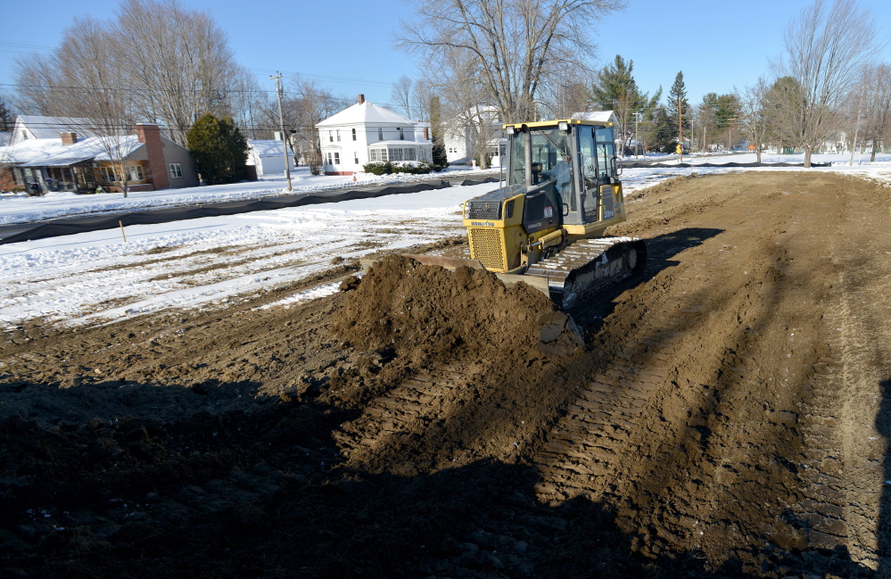 Ronald Peters levels out the site of a new public skating rink Thursday on Weston Avenue in Madison.