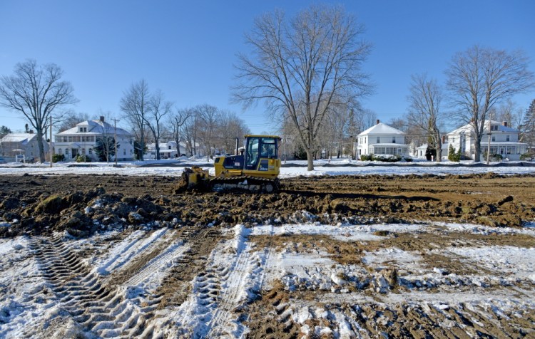 Ronald Peters levels out the site of a new public skating rink Thursday on Weston Avenue in Madison.