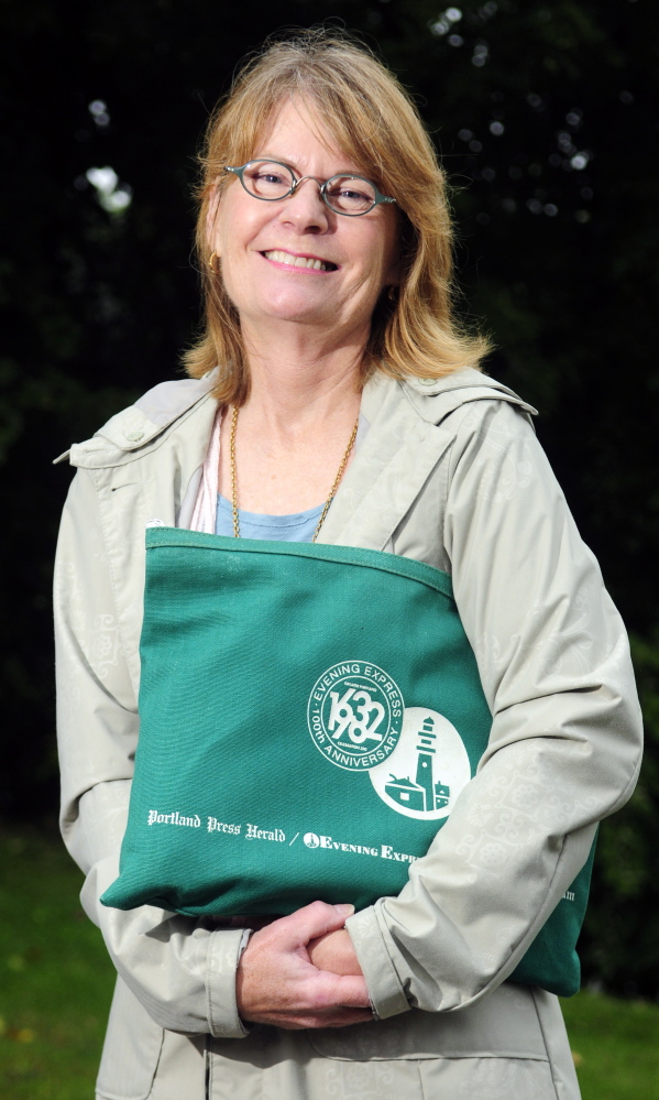 Genie Gannett, shown in this September file photo with a bag from the Portland Press Herald and Evening Express, is one of the family members who hopes to turn the Gannett House in Augusta into a First Amendment museum.