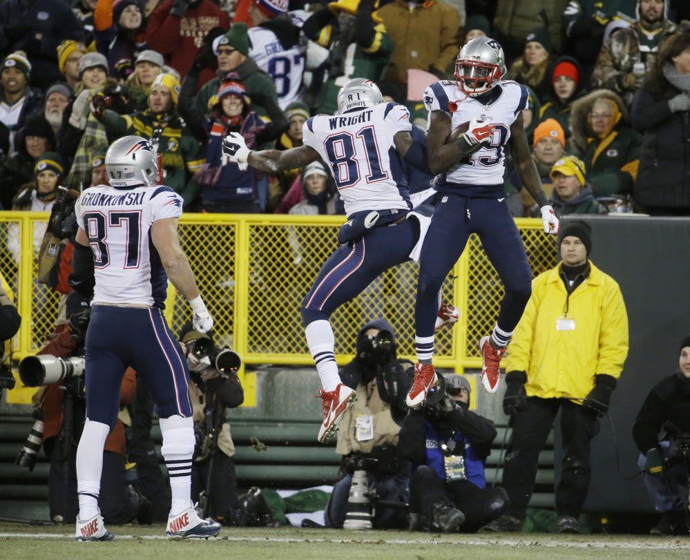 New England Patriots’ Rob Gronkowski (87) watches as Brandon LaFell (19) celebrates his touchdown catch with Timothy Wright (81) during the second half Sunday against the Green Bay Packers in Green Bay, Wis.